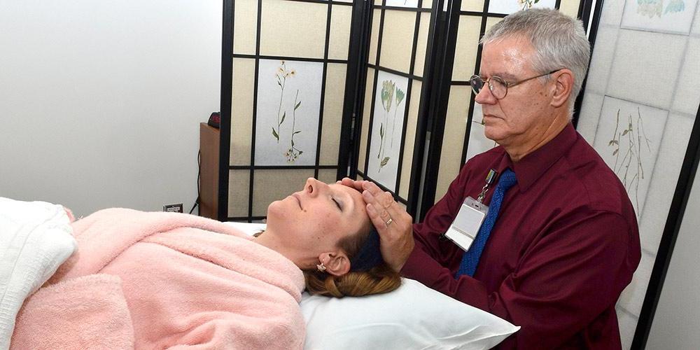 patient receiving complimentary reiki session