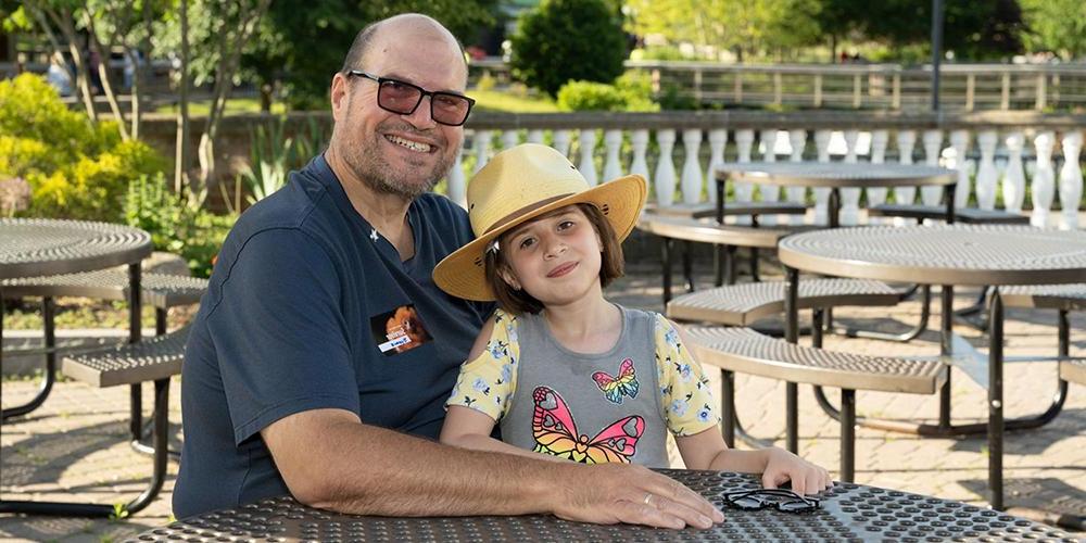 Vince Lumia, shown with Tara, his granddaughter, performed as DJ for National Cancer Survivors Day 2022 at the Rosamond Gifford Zoo at Burnet Park in Syracuse. (photo by Susan Kahn)