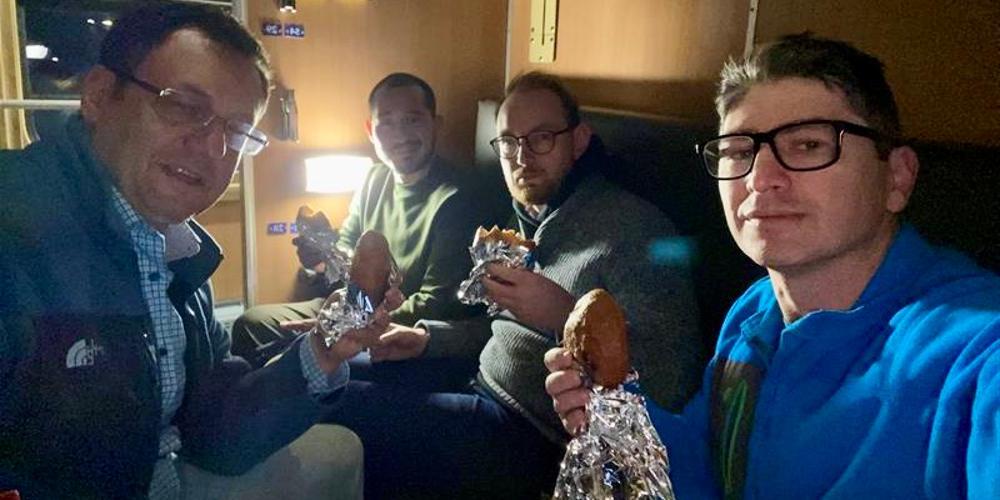 Grabbing a bite to eat aboard their train are, from left, Nikolavsky, Oszczudlowski, López and Bratslavsky.